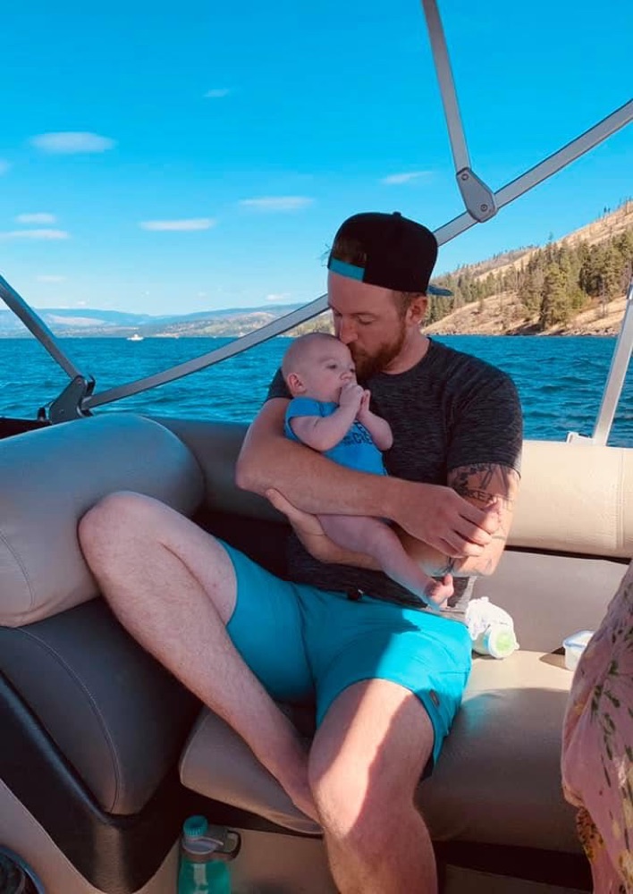 Matthew on his boat with his child